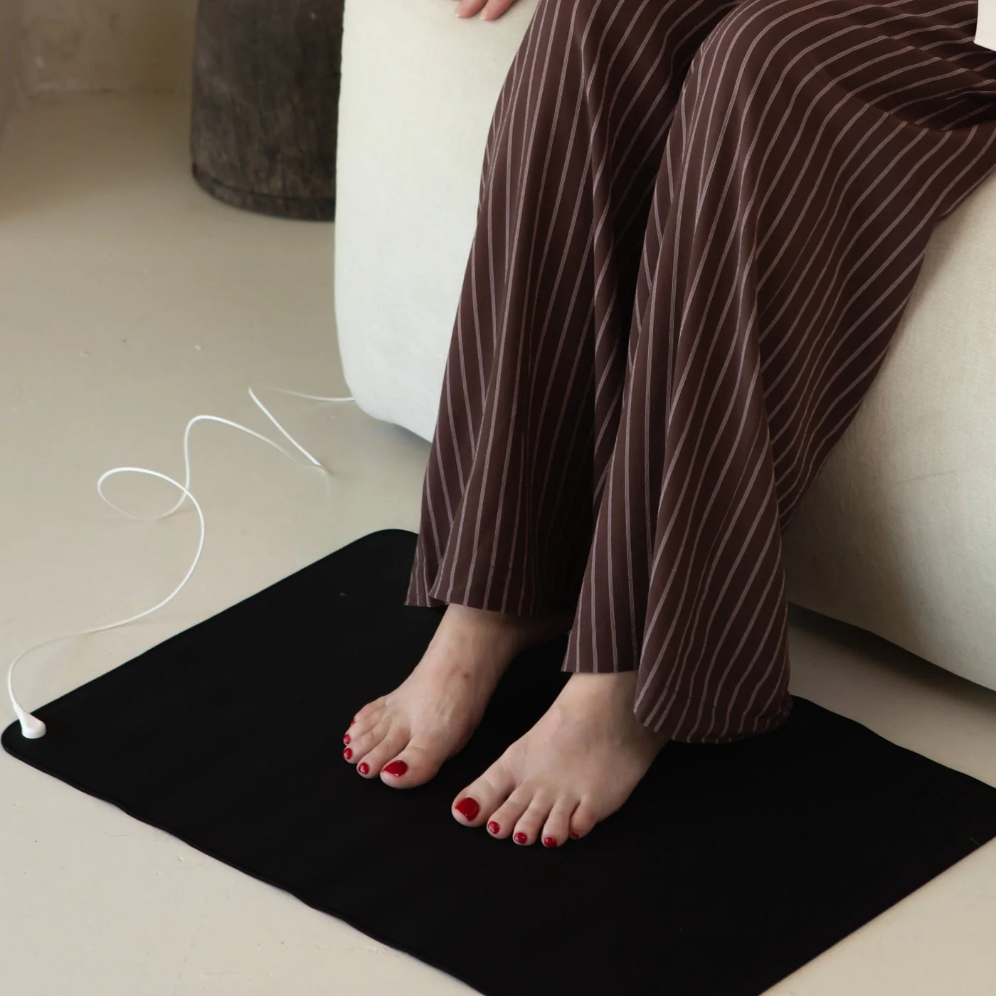 A grounding mat under a desk beside a laptop